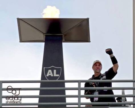 ron lighting the torch at a raiders game